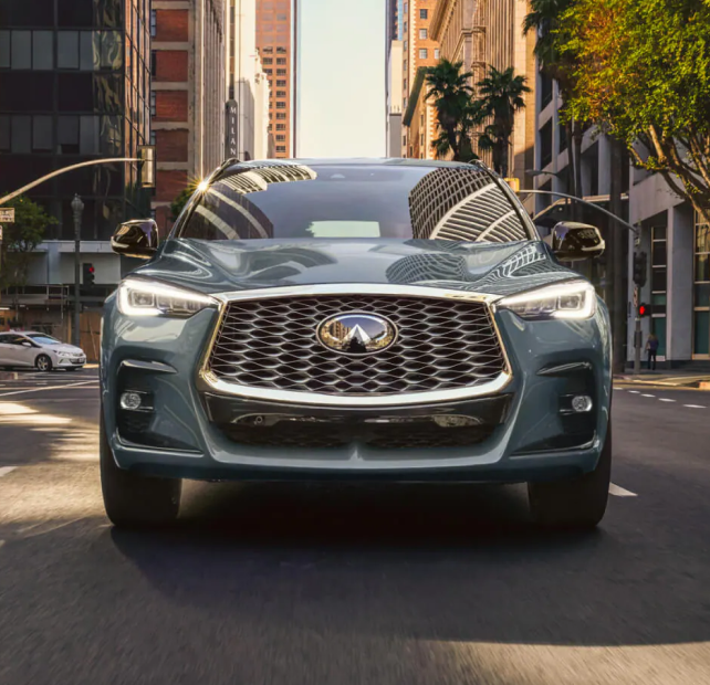 Front of a shiny INFINITI SUV driving on the road